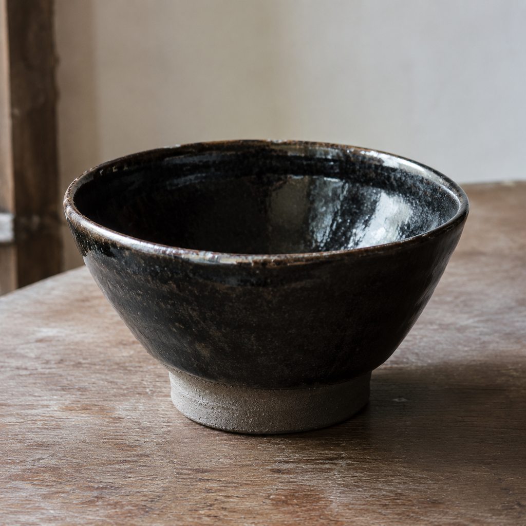 Handmade black bowl on a wooden table
